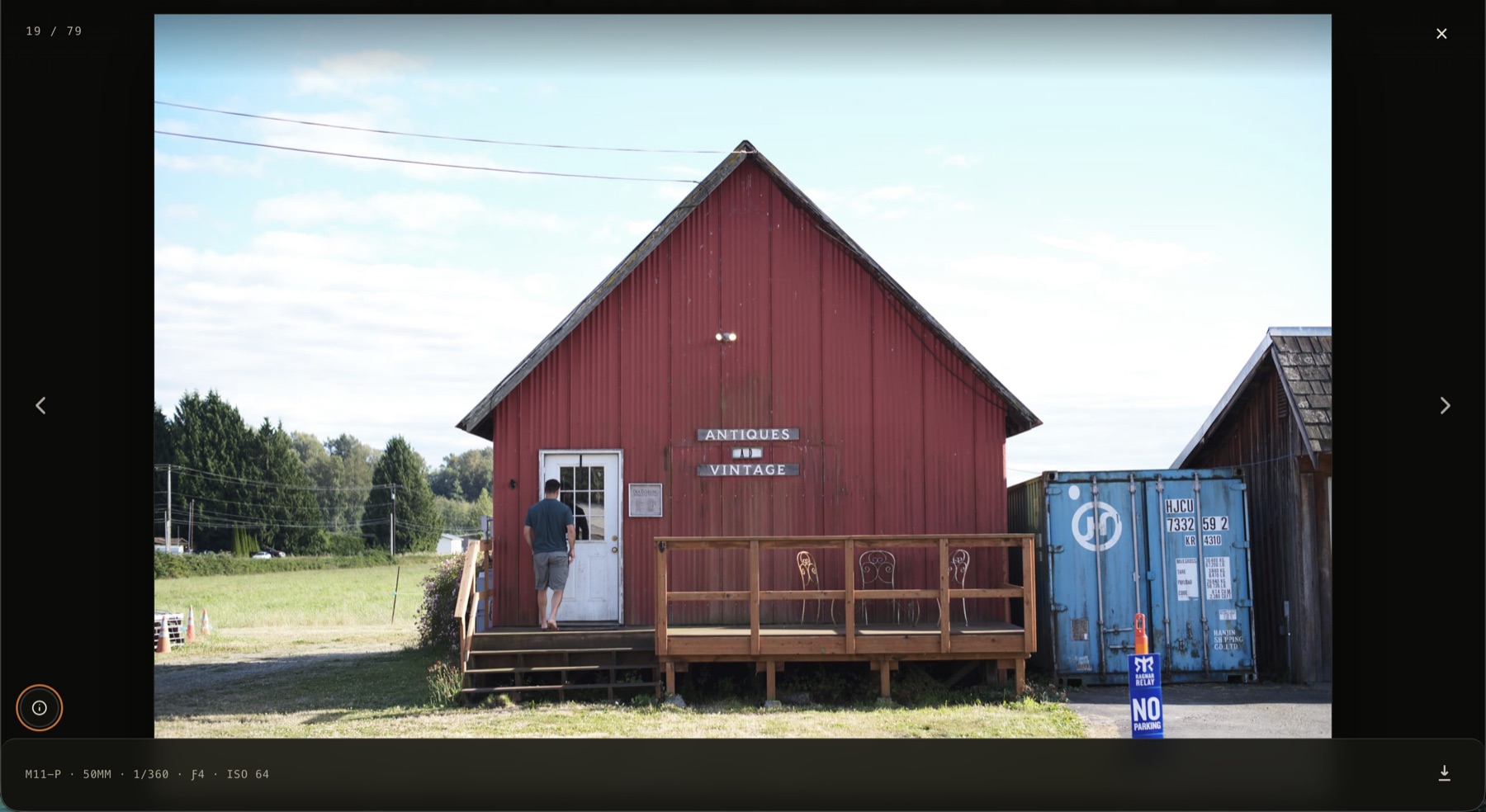 The full-screen photo viewer showing image 19 of 79 — a red barn marked Antiques and Vintage — with a camera settings plate reading M11-P, 50mm, 1/360, f4, ISO 64, and a download control